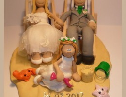 bride-groom-on-beach-with-daughter-cake-topper