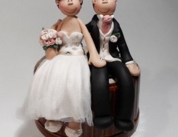 bride-groom-sitting-down-cake-topper