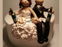 bride-groom-sitting-with-champagne-cake-topper