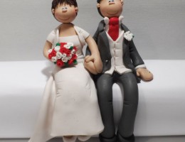 couple-sitting-cake-topper