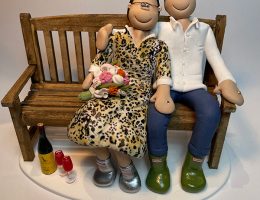 couple-sitting-on-a-bench-cake-topper