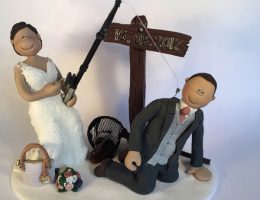 groom hooked by fishing rod cake topper